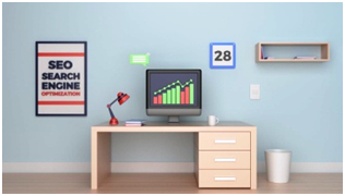 Desk with a computer displaying rising analytics, a poster about SEO optimization, and a calendar, symbolizing SEO growth and performance tracking.