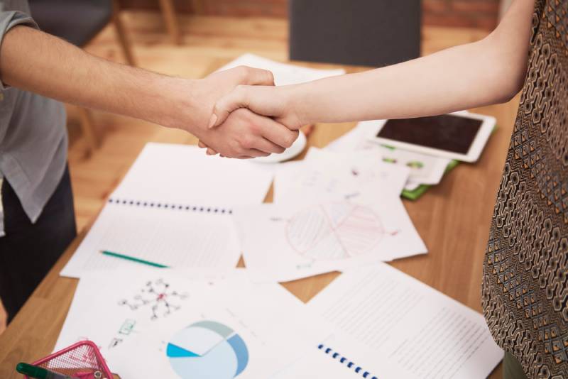 businessmen-handshake-office